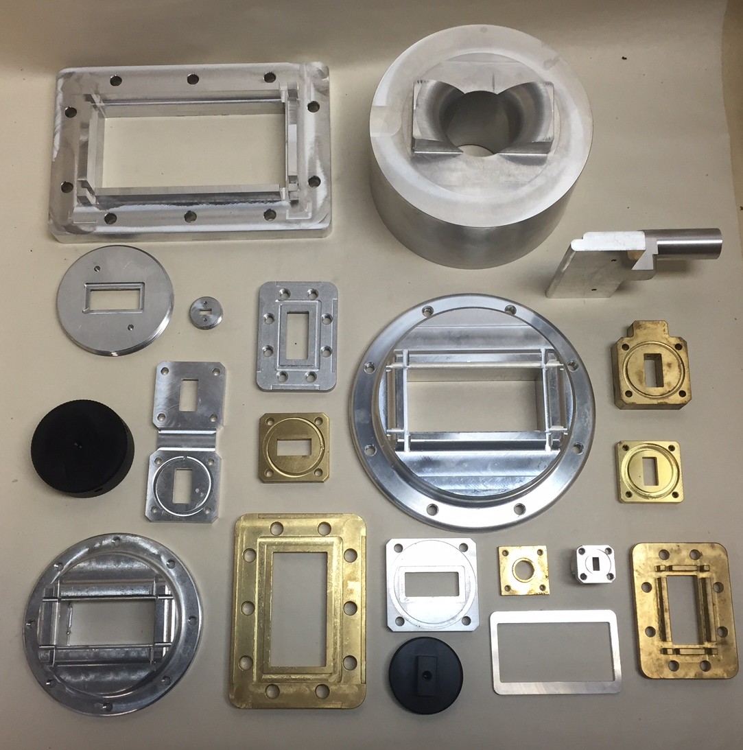 Selection of machined metal parts and components laid out for inspection