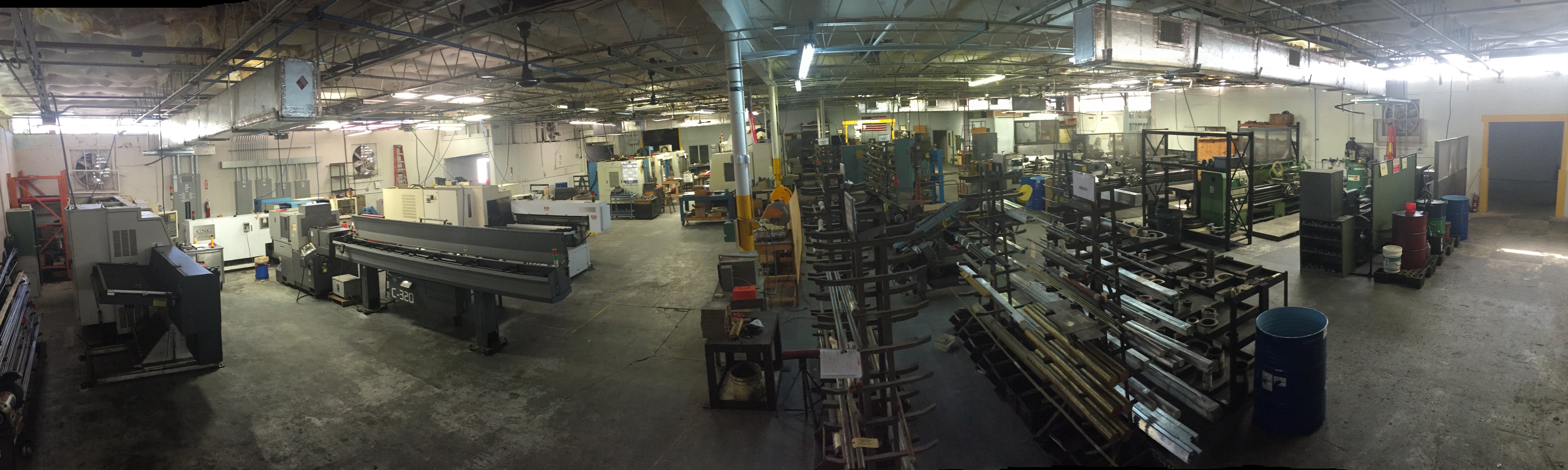 Wide view of the machine shop floor with CNC equipment and work areas